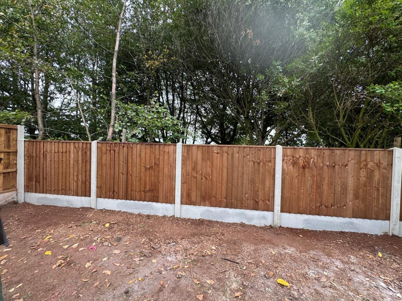 Concrete posts and gravel boards with feather edge panels
