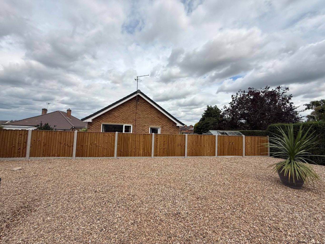 Concrete posts and gravel boards with feather edge panels